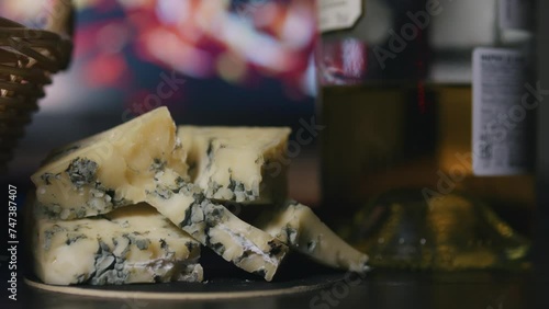 Still life of bottle of wine and blue cheese in front of burning fireplace. photo