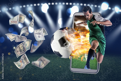 Win on sports betting, online bookmaker service. Football player kicking ball out of mobile phone and flying dollars at stadium photo