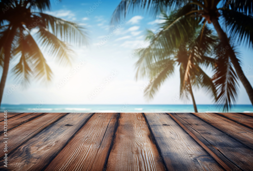 a wooden table on the beach with palm trees in the background