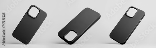 set of three smart phones in black silicone case falling down in different angles, back view isolated on grey background, phone case mockup photo