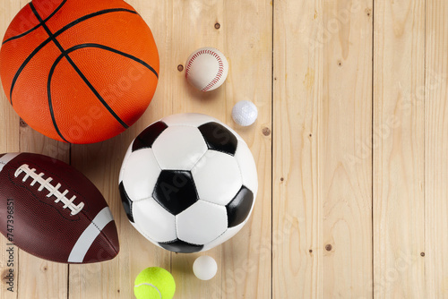Many different sports balls on wooden background  flat lay. Space for text