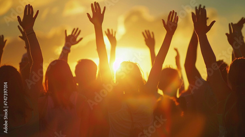 Silhouettes of a diverse group of people against a sunset, arms raised in unity and celebration, Diversity People Group Team Union, blurred background, with copy space