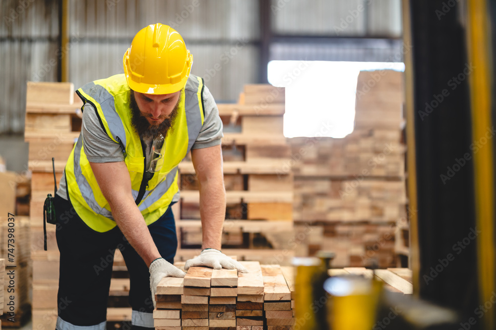 Engineer team standing walking in warehouse examining hardwood material