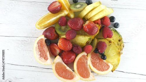 A pineapple. Fruit and berry salads. Juicy ripe slices.