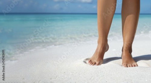 Female legs on sea beach with white sand