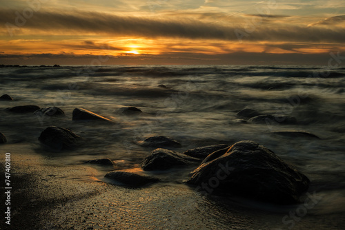 Fototapeta Naklejka Na Ścianę i Meble -  Eternal Serenity: Long Exposure Sunset at Veczemju Klintis