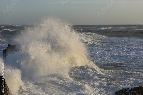 Small cape being hit by strong stormy sea waves