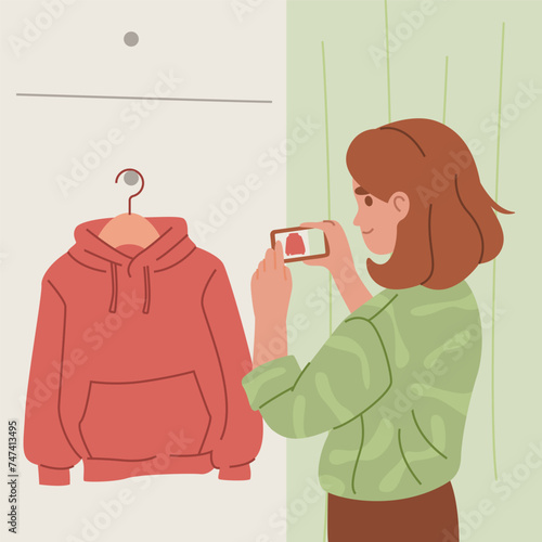 Woman Photographing Red Hoodie on Hanger.