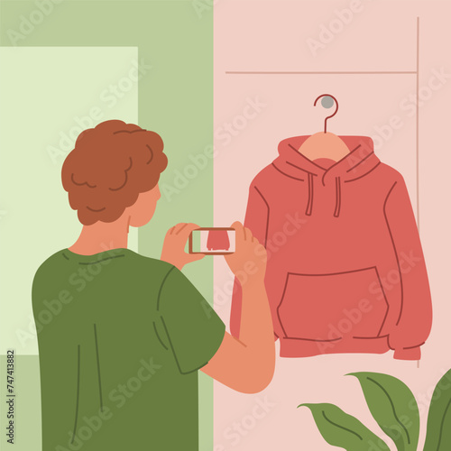 Man Photographing Red Hoodie on Hanger.