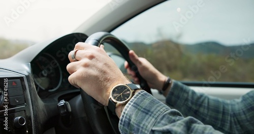 Married man, hands and driving vehicle for travel, road trip or outdoor transportation in the countryside. Closeup of male person, wedding ring and car steering wheel for holiday getaway or adventure © CineLens/peopleimages.com