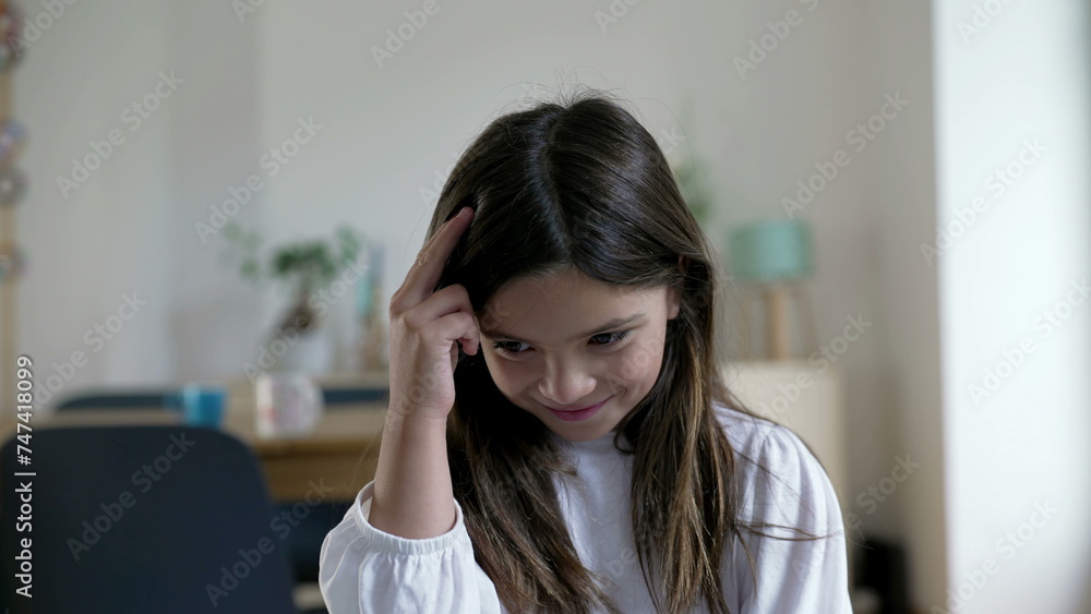 One pensive little girl having a breakthrough idea. Close-up face of a thoughtful child experiencing an eureka moment, indoors at home One pensive little girl having a breakthrough idea. Close-up face of a thoughtful child experiencing an eureka moment, indoors at home
