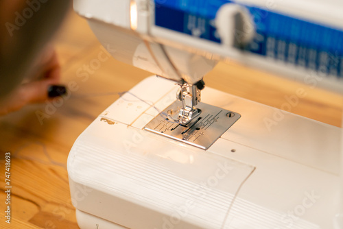 close-up in a sewing workshop a sewing machine at work by a seamstress