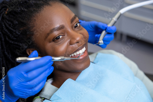 Multicultural lady in dental clinic doing teeth checkup