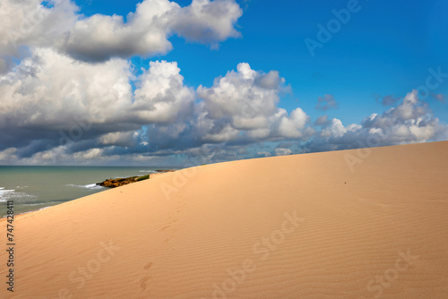 Fototapeta Naklejka Na Ścianę i Meble -  Arid landscape with sea and beautiful blue sky in the taroa dunes. Guajira, Colombia. 