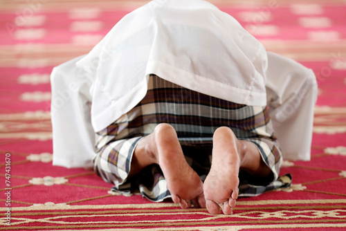 Masjid Ar-Rohmah mosque.  Muslim man praying.   Chau Doc. Vietnam. photo