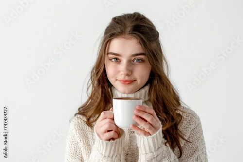 Woman in a sweater holding a cup of coffee  ideal for cozy lifestyle themes