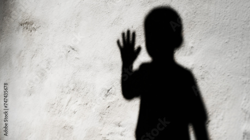 Illustration concept depicting the shadow of a child with a raised hand, symbolizing child abuse