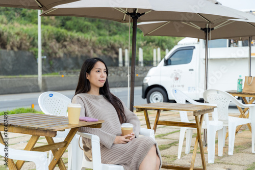 Woman enjoy the coffee shop at outdoor cafe © leungchopan