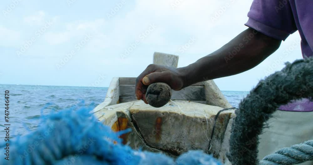 Zanzibar man driving ngalawa on the ocean on a sunny day. Zanzibar man driving ngalawa on the ocean on a sunny day.