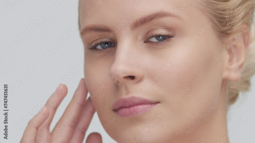Studio portrait of young, beautiful and natural blond woman applying skin care cream. Face lifting, cosmetics and make-up concept. Studio portrait of young, beautiful and natural blond woman applying skin care cream. Face lifting, cosmetics and make-up concept.
