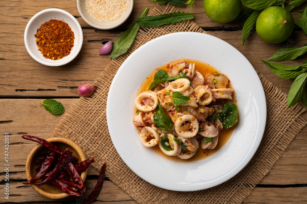 Squid Spicy Salad with Herbs,Hot and Sour Squid with Chilli, Mint leaf and Coriander in lime sauce (Yam pla muk) .Top view Squid Spicy Salad with Herbs,Hot and Sour Squid with Chilli, Mint leaf and Coriander in lime sauce (Yam pla muk) .Top view