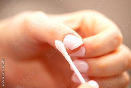 Woman removing nail varnish with acetone photo