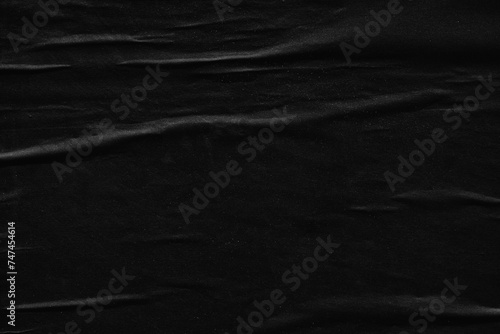Dark black creased crumpled paper background surface old posters grunge texture backdrop surface empty space for text         