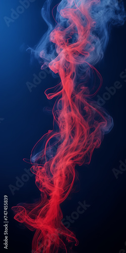 Photograph capturing the hypnotic dance of crimson smoke tendrils against a midnight blue background.