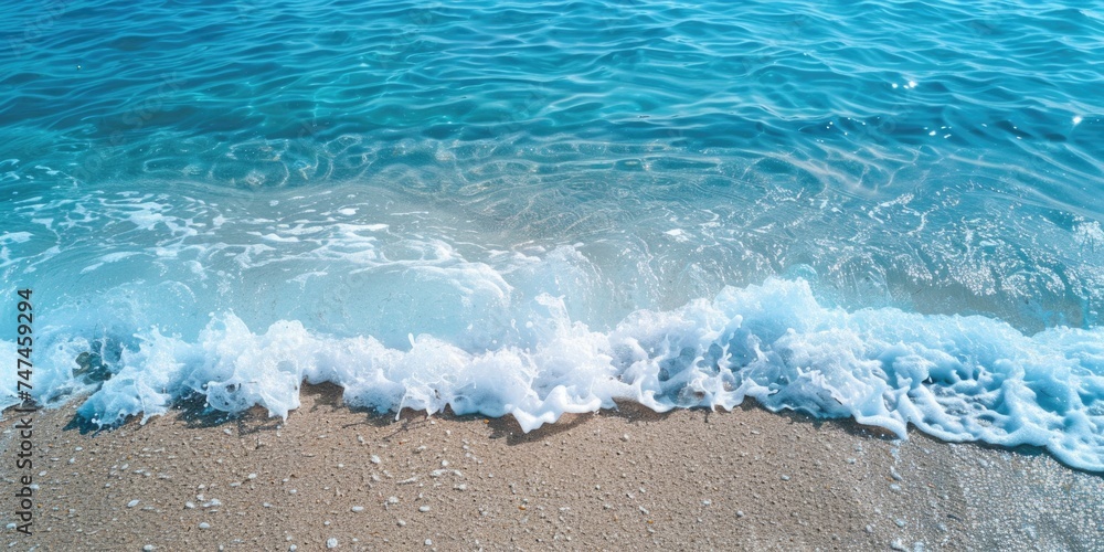 A wave rolling on a sandy beach, perfect for beach and ocean themed designs A wave rolling on a sandy beach, perfect for beach and ocean themed designs