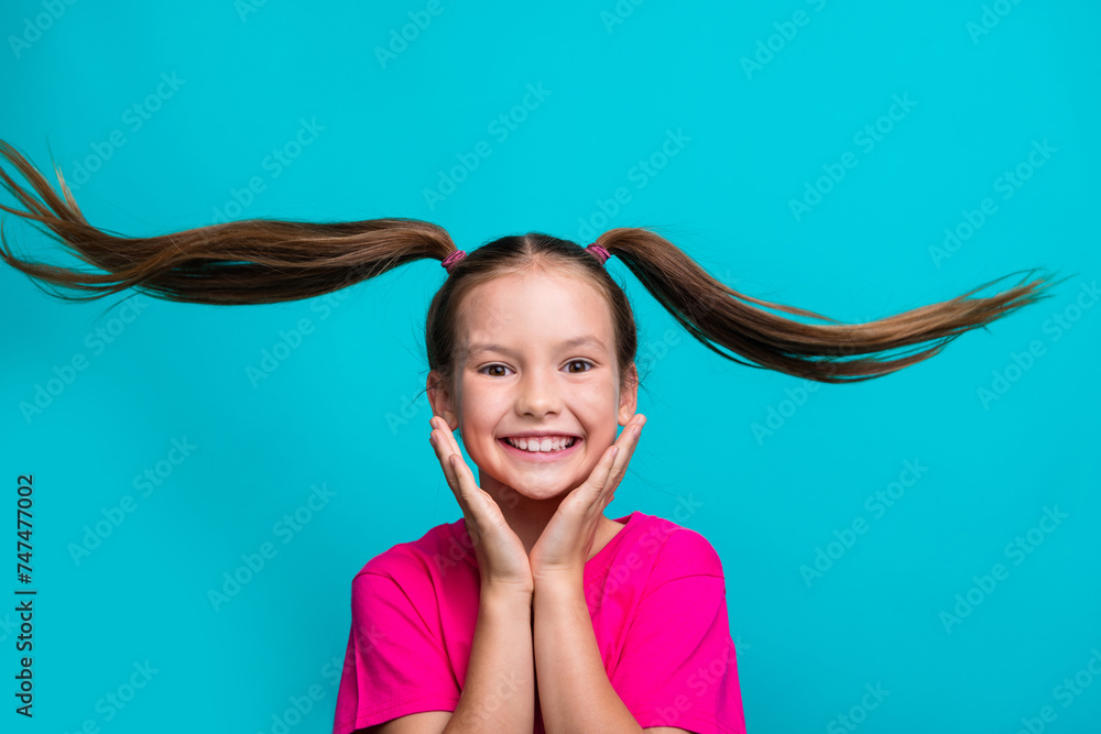 Φωτογραφία Photo of toothy beaming small girl with flying tails wear stylish t-shirt hands