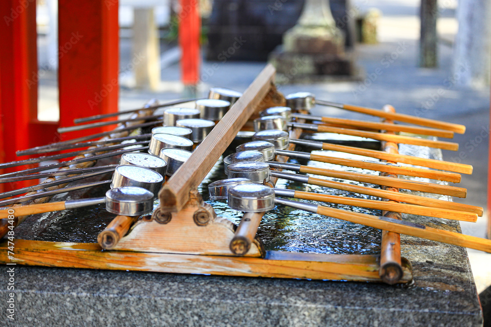 Naklejka premium Japanese metal dipper prepare for people who visit the shrine for clean mouth, hand, face.