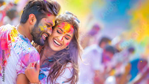 Happy Indian Couple Enjoying Holi Festival Together in Colorful Background with Crowd. Fun Loving Couple Celebrating Indian Festival Holi