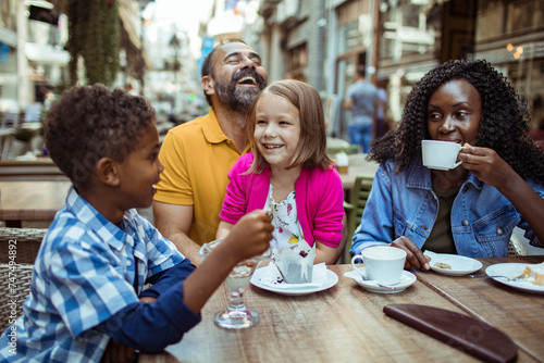 Happy multiethnic family enjoying time at a cafe together