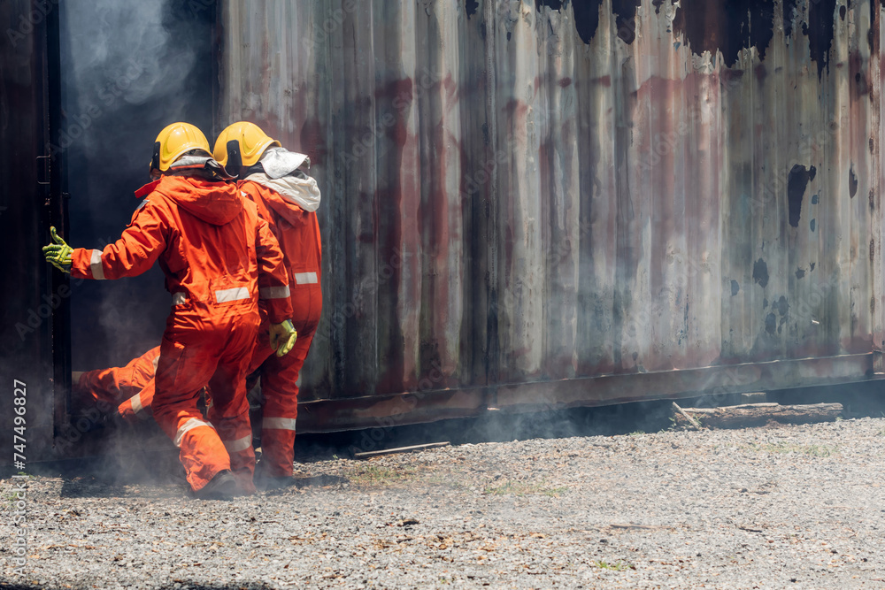 Fototapeta premium First aid support accident at work. Firefighter to save girl in fire and smoke. Rescue Team or Firefighters save lives people from fire. Firefighter or Emergency team rescue saving life people