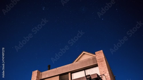 Timelapse of  stars and clear sky over a house roof 4K 30fps