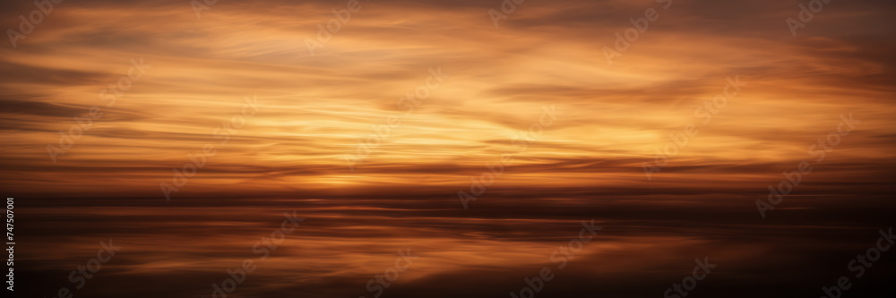 Photograph showcasing the dynamic interplay of golden and coppery smoke against a backdrop of twilight hues.