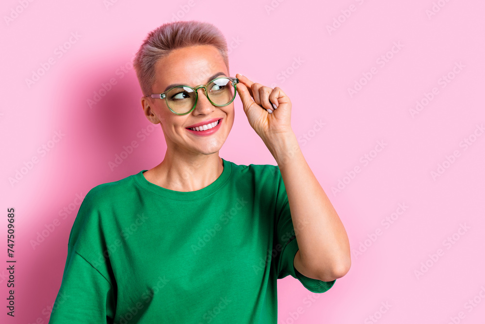 Portrait of lovely minded girl beaming smile arm touch glasses look empty space isolated on pink color background Portrait of lovely minded girl beaming smile arm touch glasses look empty space isolated on pink color background