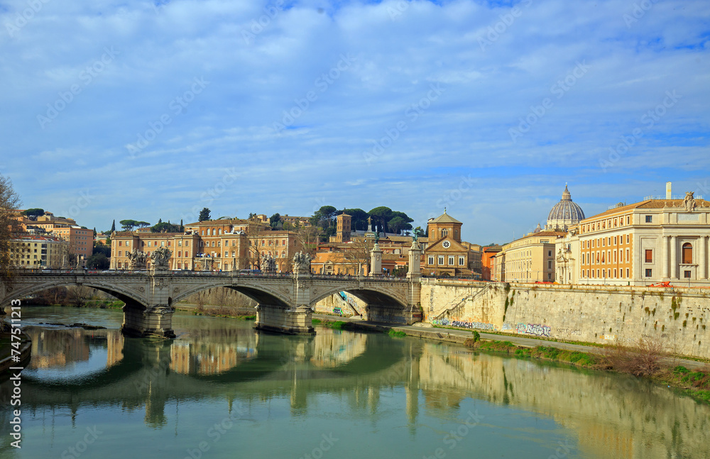Scenic view over the River Tiber with reflection of arched bridge and Vatican Basillica in the distance, Rome, Italy