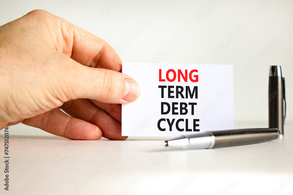 Long term debt cycle symbol. Concept words Long term debt cycle on beautiful white paper. Beautiful white background. Businessman hand. Business Long term debt cycle concept. Copy space. Long term debt cycle symbol. Concept words Long term debt cycle on beautiful white paper. Beautiful white background. Businessman hand. Business Long term debt cycle concept. Copy space.