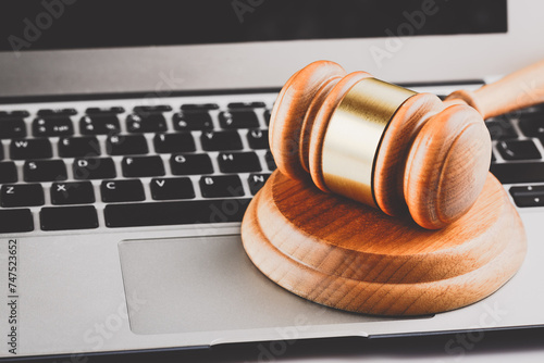 Online auction or cyber law concept. Judge court gavel on a modern laptop computer