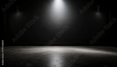 Experience the allure of an empty room with black walls and a spotlight, creating a dramatic setting for text mockups or product presentations.