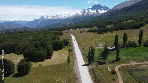 Camera moving along the Carretera Austral route Chile with jagged black snowcapped mountains in the distance