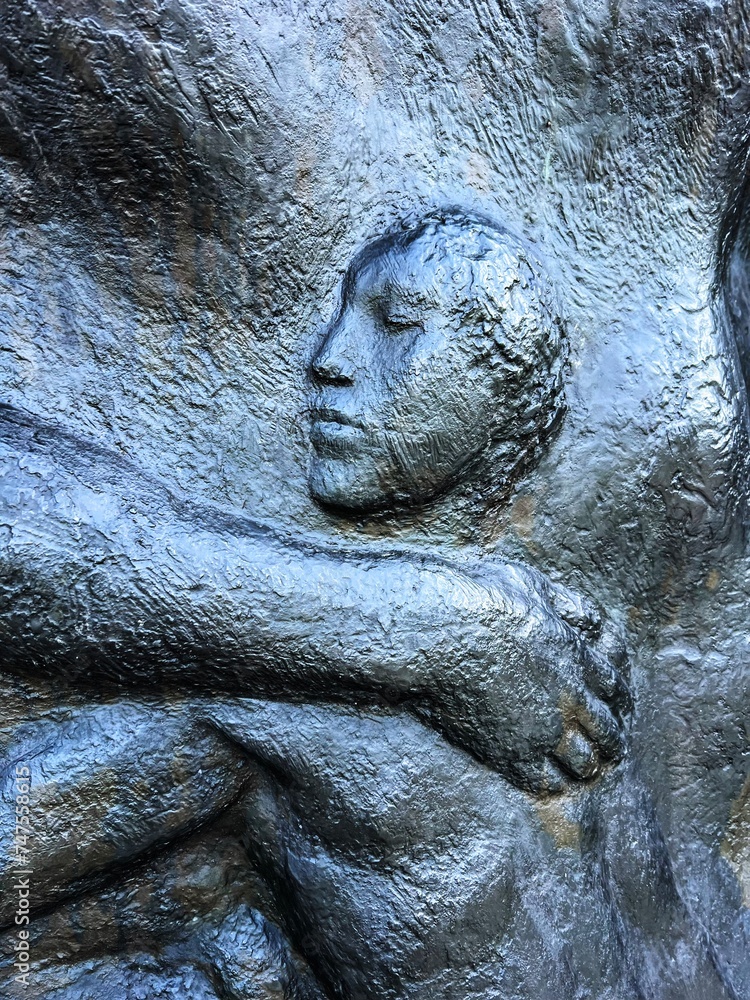 bas-relief figure of a girl on metal