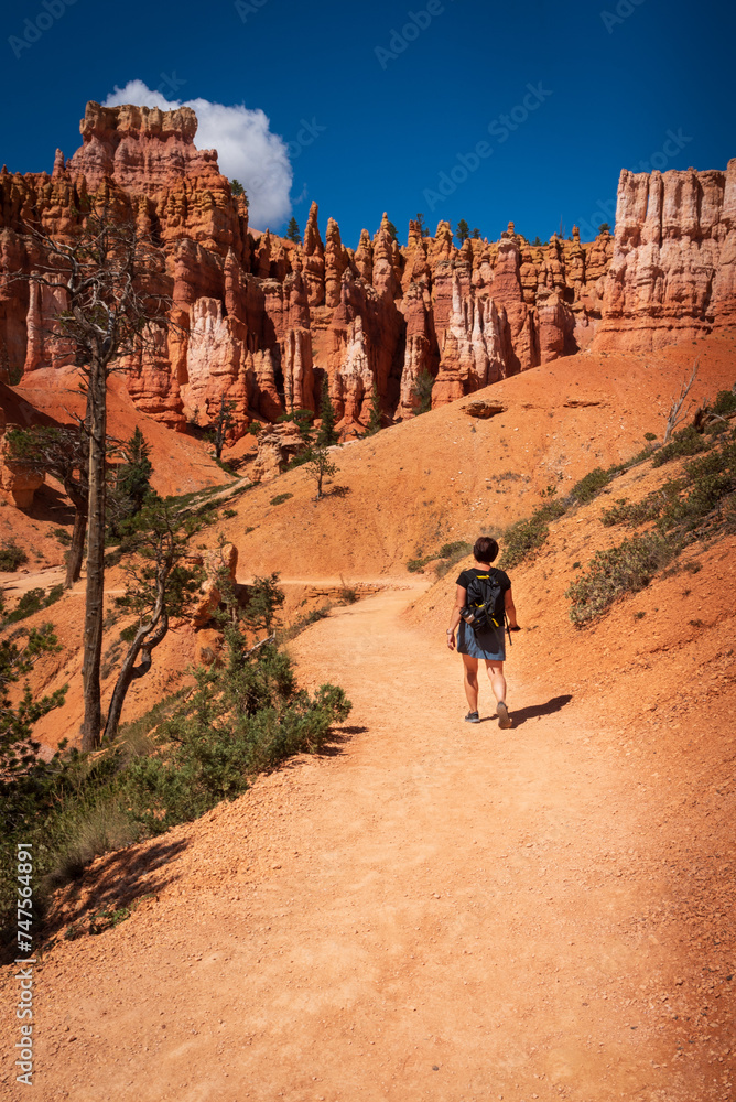 Middle-aged woman hiking the Queen’s Garden Trail in Bryce Canyon National Park, Utah.