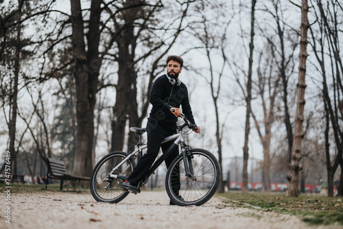 A businessman in casual attire takes a break to cycle in the park, reflecting a balance of entrepreneurship and health.