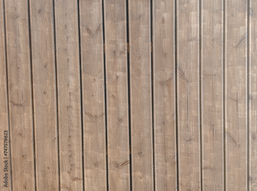 Fototapeta premium Siberian larch fluted wood terrace impregnated with oil before painting. Decking of wooden planks