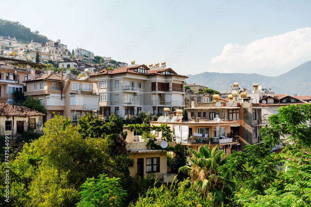 A cascade of multilevel homes nestled amidst greenery on a Mediterranean hillside