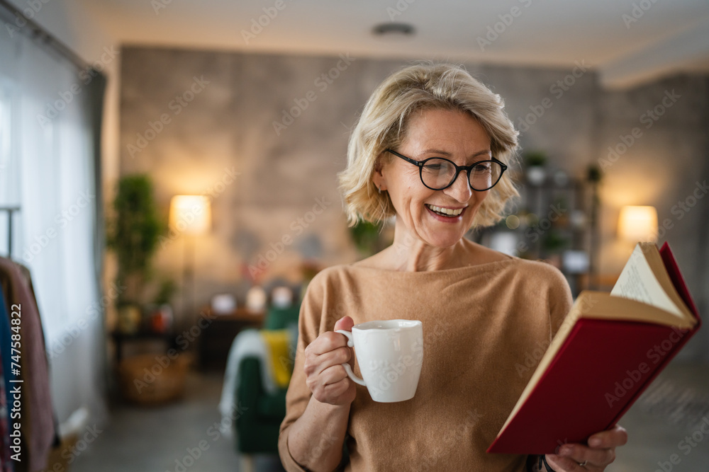 One woman mature caucasian female read book at home wear eyeglasses One woman mature caucasian female read book at home wear eyeglasses