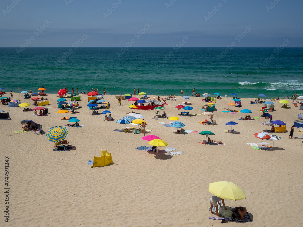 Keeping social distancing at the beach under the umbrellas Keeping social distancing at the beach under the umbrellas