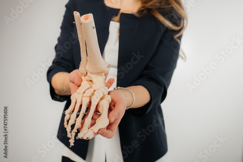 Doctor explaining operation to foot on bone model